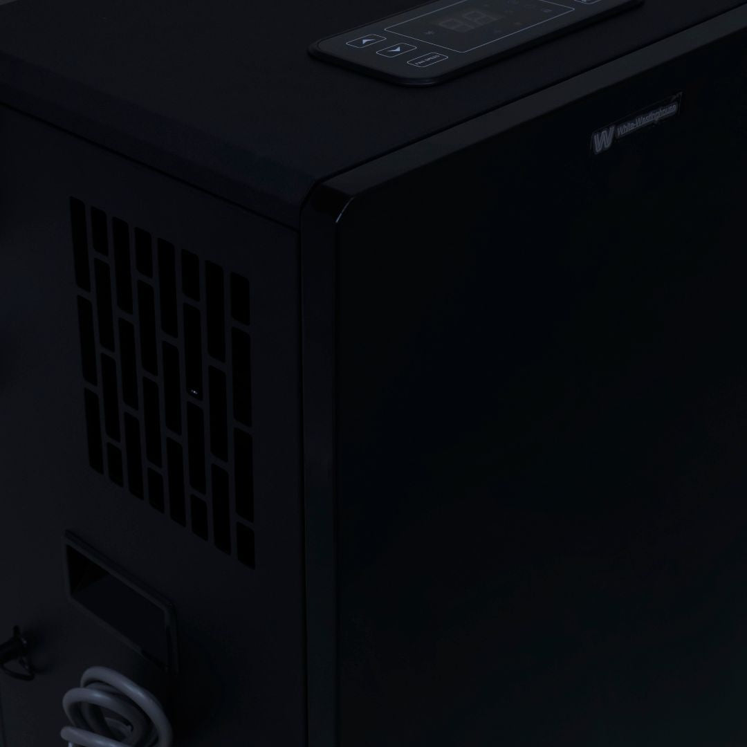 White Westinghouse WDE 100 dehumidifier by JET INDIA, showing a large appliance with digital controls and a water collection tank.